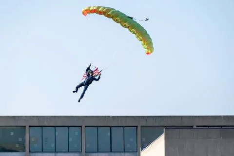 Skydiver over building Stock Photos