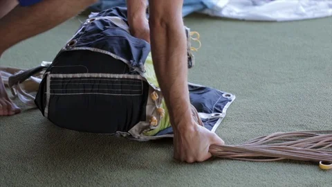 Skydiver parachute packing close up. Hands folding parachute lines getting ready 스톡 동영상 115994030