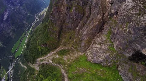 Skydiver parachuting between mountains covered by greenery and snow. Danger Stock Footage 67421467