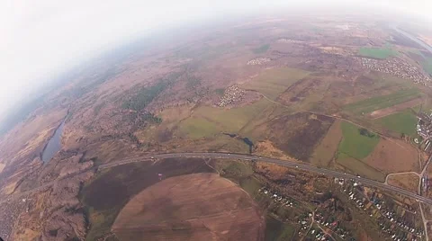 Skydiver parachuting in cloudy sky above city in evening. Extreme. Landscape Stock Footage 66747861