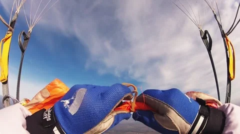 Skydiver parachuting in cloudy sky above river, fields. Sport. Landscape. Flight Stockbeeldmateriaal 66747965