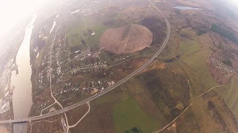 Skydiver parachuting in cloudy sky above green field, city, river. Extreme sport Видео 96442867