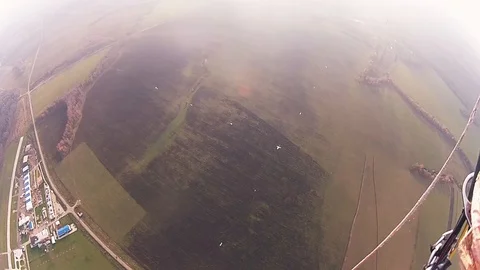 Skydiver parachuting in cloudy sky in evening. Extreme sport. Landscape. Flight Stock Footage 96440394