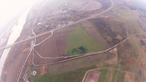 Skydiver parachuting in cloudy sky in evening. Extreme sport. Landscape of river Видео 96443213