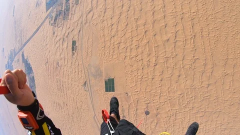 Skydiver parachuting over the desert dunes 스톡 동영상 101737536