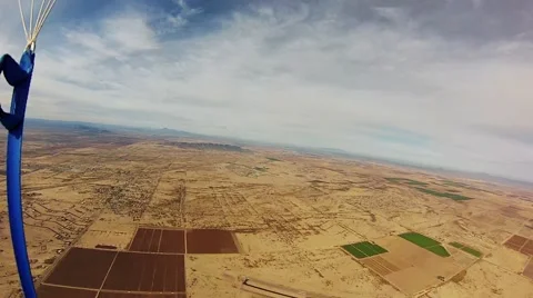 Skydiver parachuting in sky over sands of Arizona. Extreme sport. Adrenaline Stock Footage 68218314