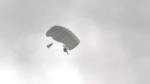 A skydiver is planning in a cloudy sky. Stock Footage 178458143
