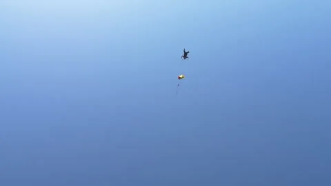 Skydiver Plummets Through the Blue Sky Toward the Ground Stock Footage 208737637