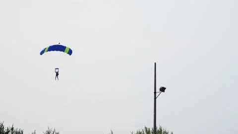 Skydiver slowly lands in a field. Stock Footage 220217831