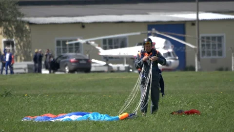 Skydiver stows parachute after jump. Stock Footage 199830587
