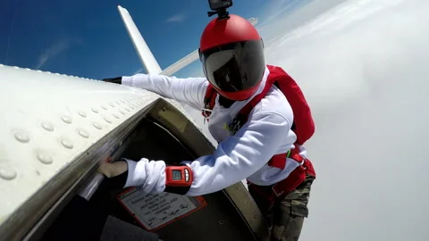 Skydivers Fall From the Open Door of a Single-Engine Plane Stock Footage 208738360