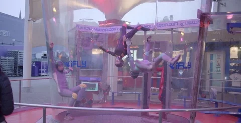 Skydivers Float In Wind Tunnel Together 2 Stock Footage 76497559