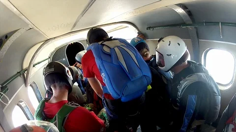 Skydivers getting ready to jump form an airplane. Group of adventure seeking ext Stock Footage 106219848