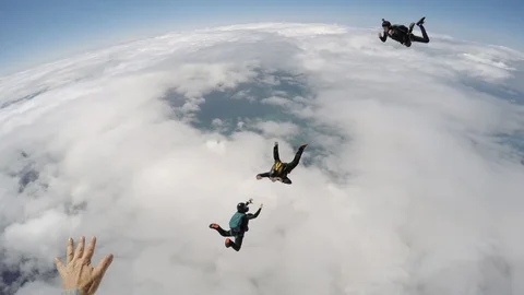 Skydivers having fun above the clouds Stock Footage 89783495