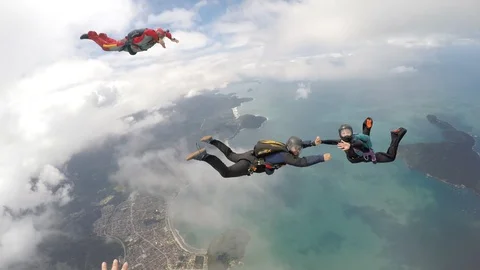 Skydivers having fun above the clouds Stock Footage 89814370