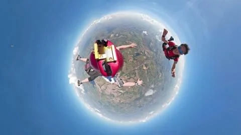 Skydivers having fun small planet view Foto stock