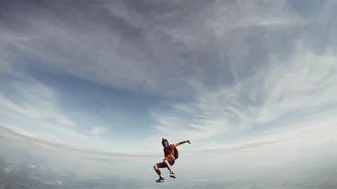 Skydivers jump from airplane in cloudy sky. Sun. Extreme sport. Group. Formation Stock Footage 152065044