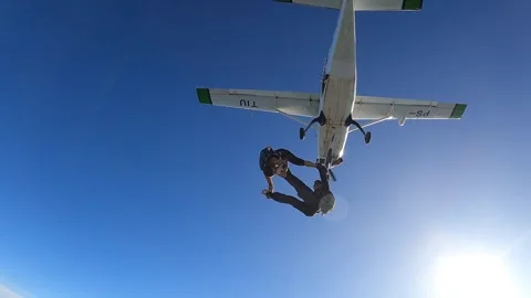 Skydivers jump out of plane Stock Footage 302396033