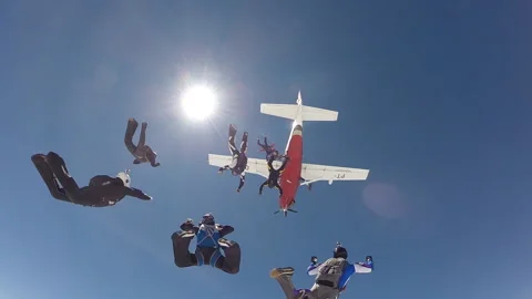 Skydivers jumping out the plane above the clouds slow motion Stock Footage 122929560