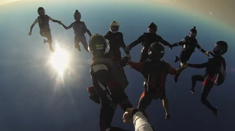 Skydivers make formation above Dubai in sky. Sunny day. Extreme sport. Cityscape Stock Footage 67557620