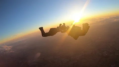 Skydivers make a formation skydive at the sunset Stock Footage 120482364