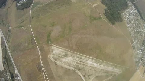 Skydivers parachuting in sky over green flatland. Extreme sport. Landscape Stockbeeldmateriaal 152064784