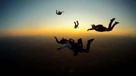 Skydivers playing at the sunset Video stock 60061728