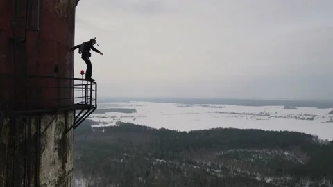 Skydiving from a 150-meter abandoned industrial pipe, extreme skydiving Stock Footage 220574146