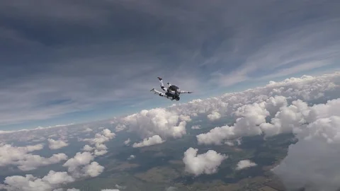 Skydiving, free fall, a man in the clouds, parachutists jump out of an airplane 스톡 동영상 172089161