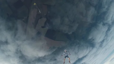 Skydiving, free fall, a man in the clouds, parachutists jump out of an airplane Stock Footage 172089184