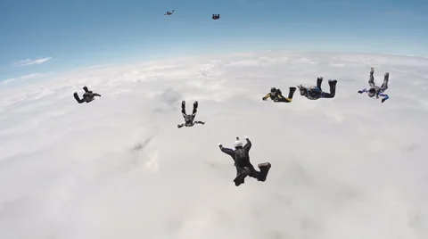 Skydiving group above de clouds Stock Footage 58560252
