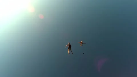 Skydiving a group of skydivers jumps at sunset Stock Footage 197405757