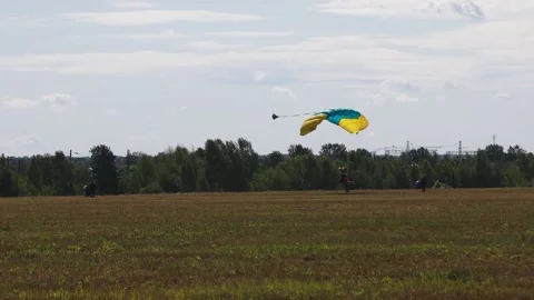Skydiving. The parachutist lands on the ground Stock Footage 247270501