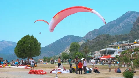 Skydiving with red paraglide soaring. 動画素材 249660414