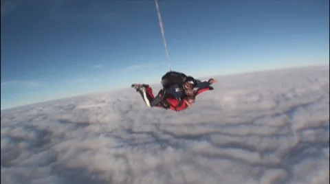 Skydiving tandem above the clouds Stock Footage 61297938