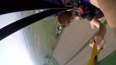 Skydiving in tandem with an instructor Stock Footage 244304643