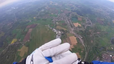 Skydiving tandem opening parachute at high speed - POV instructor earth Stock Footage 241559931