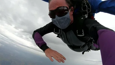 Skydiving tandem with protective mask after the lockdown Stock Footage 132212712