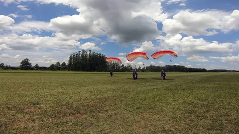 Skydiving team landing touching down together Stock Footage 159658617