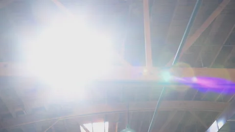 Skylight window on the ceiling in a building with sun rays and dust flying in Stockbeeldmateriaal 291575767