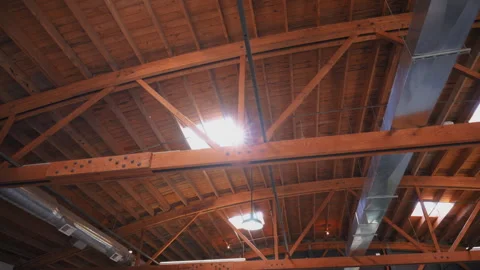 Skylight window on the ceiling in a building with sun rays and dust flying in Stockbeeldmateriaal 291576519