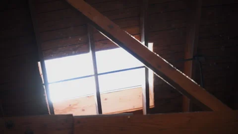 Skylight window on the ceiling in a building with sun rays and dust flying in Stockbeeldmateriaal 291580529