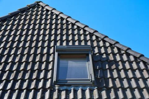 Skylight Window with External Roller Shutter on Rooftop with Black Tiles Fotos de archivo