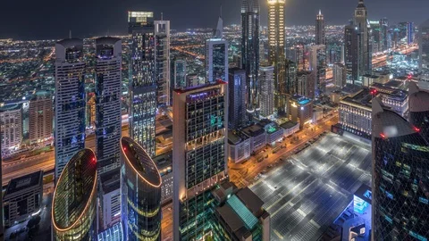 Skyline of the buildings of Sheikh Zayed Road and DIFC aerial night timelapse in Stock Footage