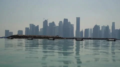 The Skyline of Doha, Qatar, from the sea, with reflections on the water Stock Footage 150959837