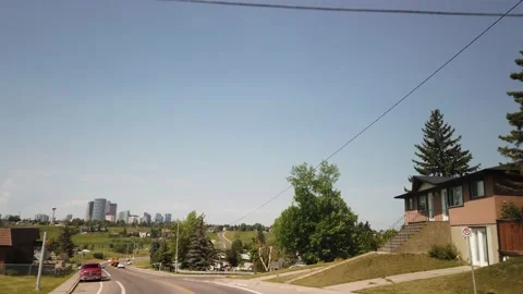 Skyline driving suburbs of Calgary during summer day Stock Footage 146801191