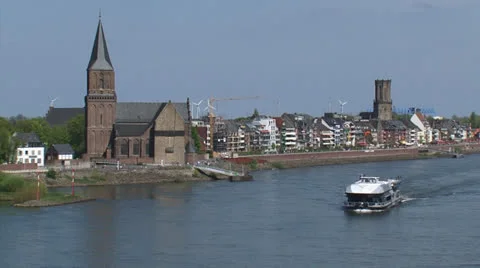 Skyline Emmerich, Germany + tourist boat cruising river Rhine Stock Footage