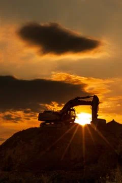 Skyline excavator with colored sunset Stock Photos