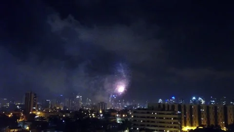 Skyline illuminated by colourful firework display and the city lights Stock Footage 257061846