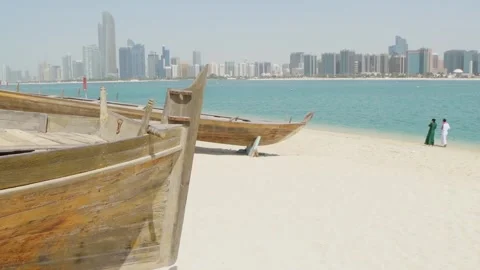 Skyline of modern Abu Dhabi and old traditional fishing boats in Heritage V.. Stock-Footage 324938239